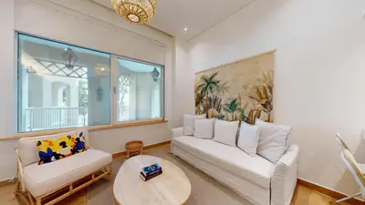 a living room with two white couches and a table at Al Dabas 2 - Calm One Bedroom in Palm Jumeirah in Dubai