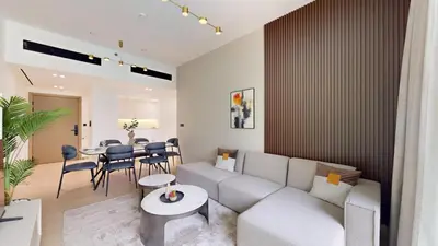 a living room with a couch and a table at Binghatti Crescent - Two Bed with Pool View in JVC in Dubai