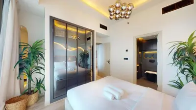 a bedroom with a white bed and plants at Ocean Heights - Upgraded Two Bed with Sea View in Dubai