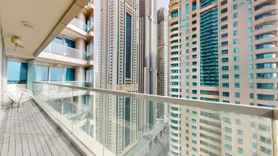 a balcony in a building with tall buildings at Ocean Heights - Upgraded Two Bed with Sea View in Dubai