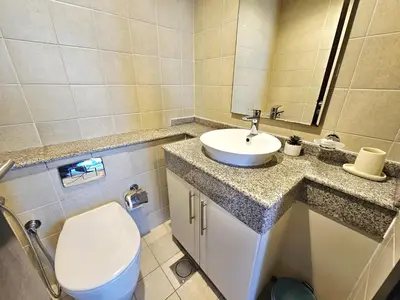 a bathroom with a toilet and a sink at Amazing 1BR High-floor with Breathtaking View near Marina Walk in Dubai