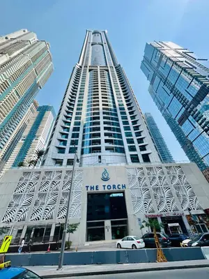 a tall building with a car parked in front of it at Amazing 1BR High-floor with Breathtaking View near Marina Walk in Dubai