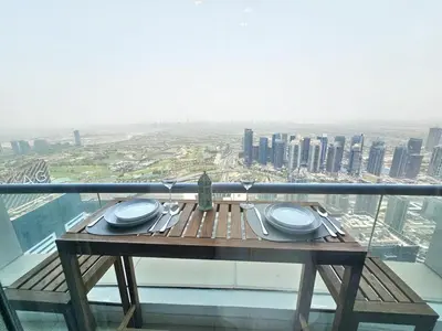 a table on the top of a building with a view at Amazing 1BR High-floor with Breathtaking View near Marina Walk in Dubai