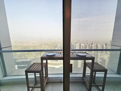 a table and two chairs in front of a window at Amazing 1BR High-floor with Breathtaking View near Marina Walk in Dubai