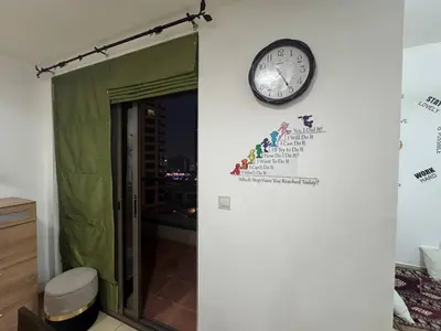 a clock on a wall next to a door at Happyland JBR Dubai Hostel in Dubai