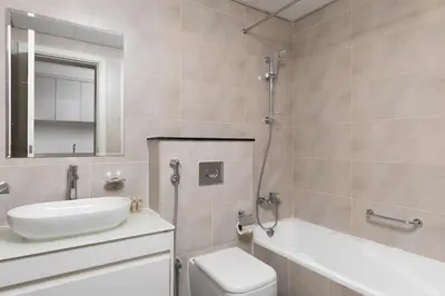 a bathroom with a sink and a toilet and a tub at Maison Privee - Stylish Studio with Top Facilities in Damac Hills in Dubai