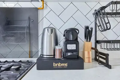 a blender sitting on a counter next to a stove at bnbmehomes - Afnan 4 - Midtown in Dubai