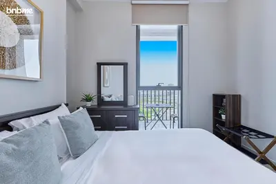 a bedroom with a white bed and a mirror at bnbmehomes - Afnan 4 - Midtown in Dubai
