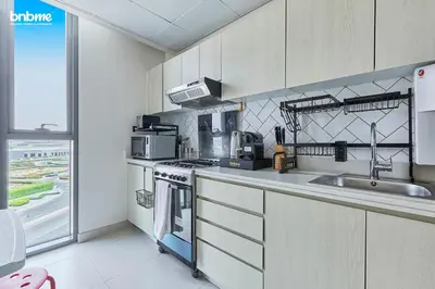 a kitchen with a sink and a stove top oven at bnbmehomes - Afnan 4 - Midtown in Dubai
