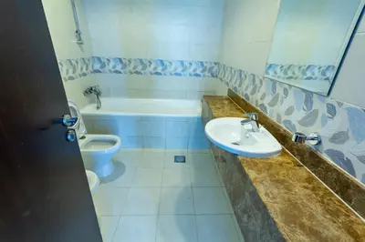 a bathroom with a sink and a tub and a toilet at Rental Small Rooms for female guest in the heart of Dubai بنات فقط in Dubai