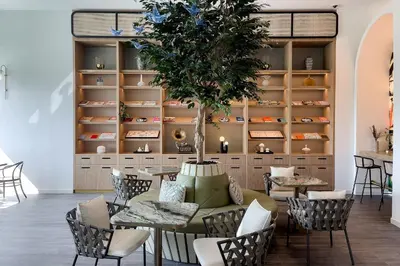 a room with a table and chairs and a tree at Dubai Hills Cozy 1Br Golfville in Dubai