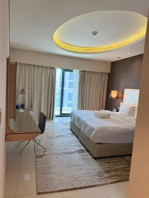 a bedroom with a bed and a yellow ceiling at 2BR Apartment in Paramount Hotel with Burj Khalifa View in Dubai
