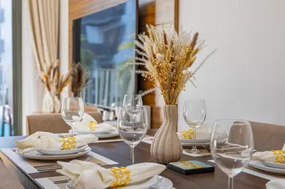 a dining room table with glasses and plates on it at Contemporary 2-BR at Belgravia Square JVC in Dubai
