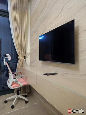 a desk with a chair and a television on a wall at EGATE - Studio - 4th Floor - Balcony with a View - 20-423 in Dubai