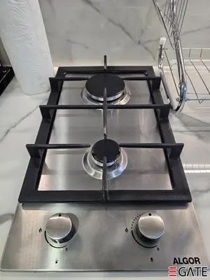 a stove top with three burners on top of it at EGATE - Studio - 4th Floor - Balcony with a View - 20-423 in Dubai