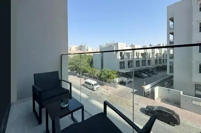 a balcony with a chair and a view of a city at Stylish Duplex Autograph 1BR in Dubai