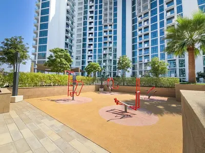 a playground in a park with tall buildings at EasyGo- City Center, Spacious, Skyline view in Dubai