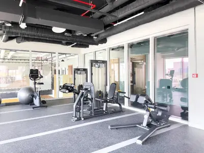 a gym with treadmills and ellipticals in a building at Chic & Modern 1BR in Socio Near Dubai Hills Park in Dubai