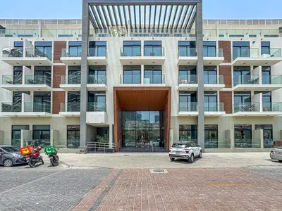 a large building with cars parked in front of it at Savis Homes - Luxury Brand New Studio in Elysee III in JVC in Dubai