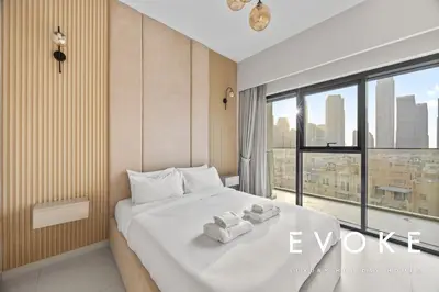 a bedroom with a bed with two towels on it at Full Burj & Fountain View - Evoke 2BR at Burj Royale in Dubai