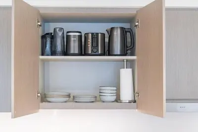 a cupboard with a bunch of pots and pans at New 1BR Burj view- Infinity Pool - Dubai Mall in Dubai