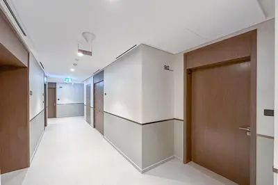 a hallway of an office building with a row of doors at New 1BR Burj view- Infinity Pool - Dubai Mall in Dubai