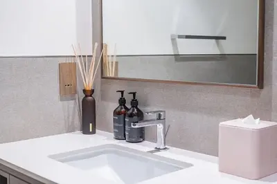 a bathroom sink with two bottles and a mirror at New 1BR Burj view- Infinity Pool - Dubai Mall in Dubai