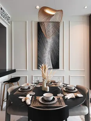 a dining room with a black table with chairs and a chandelier at Downtown Escape 2BR with Full BurjKhalifa Panorama in Dubai