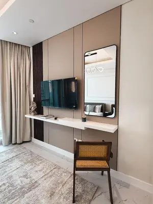 a dressing room with a mirror and a chair at Downtown Escape 2BR with Full BurjKhalifa Panorama in Dubai