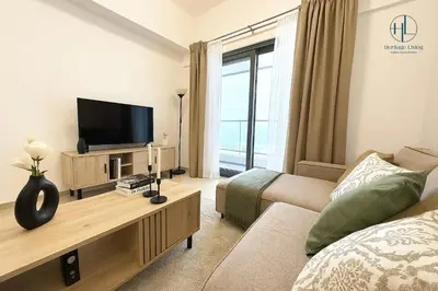 a living room with a tv and a couch at Downtown Living - Business Bay 1BR in Dubai