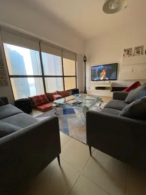 a living room with two couches and a flat screen tv at Alsahel Vacation 1 in Dubai
