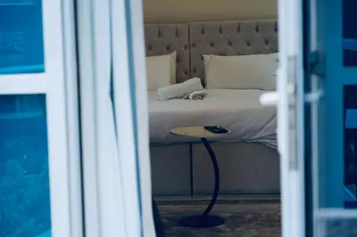 a bedroom with a bed with a table next to it at JBR Studio Apartment - Bay Central in Dubai