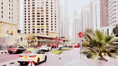 a busy city street with cars parked on the road at JBR Studio Apartment - Bay Central in Dubai