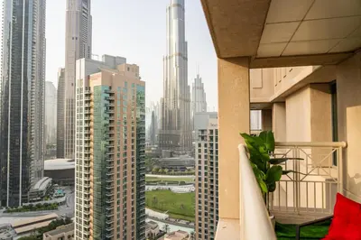 a view of a city from the balcony of a building at The Boulevard Suite Stunning Burj Khalifa View Downtown in Dubai