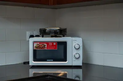 a microwave sitting on top of a counter at The Boulevard Suite Stunning Burj Khalifa View Downtown in Dubai