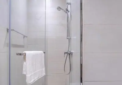 a bathroom with a shower with a glass door at Cosy studio in Dubai