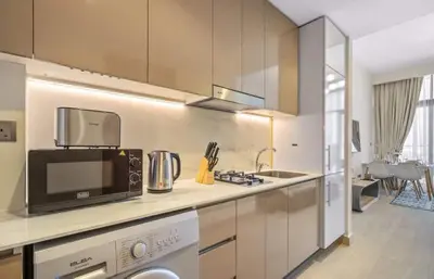 a kitchen with a sink and a microwave at Azizi Riviera , Meydan, Dubai Burj Khalifa view in Dubai