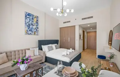 a living room with a bed and a couch at Azizi Riviera , Meydan, Dubai Burj Khalifa view in Dubai