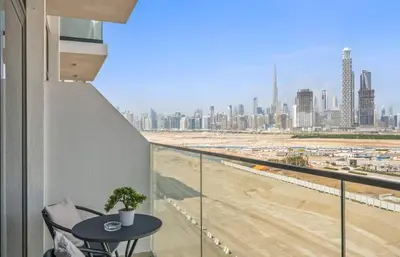 a balcony with a table and a view of a city at Azizi Riviera , Meydan, Dubai Burj Khalifa view in Dubai