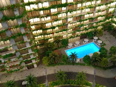 an overhead view of a large apartment building with a swimming pool at California Village Dubai in Dubai