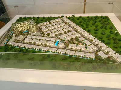 a model of a building complex on a table at California Village Dubai in Dubai