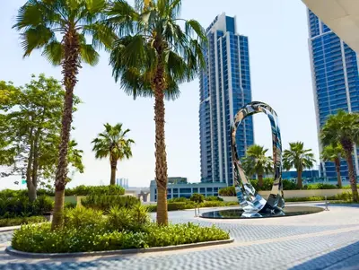 a fountain with palm trees and buildings in the background at ADDRESS BEACH RESORT Residence Million Dollar View 39th floor DXB AIRPORT VIP Shuttle option in Dubai