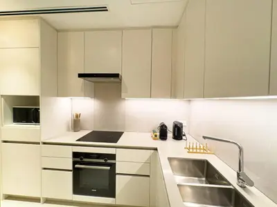 a kitchen with white cabinets and a sink at ADDRESS BEACH RESORT Residence Million Dollar View 39th floor DXB AIRPORT VIP Shuttle option in Dubai