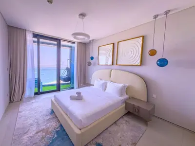 a bedroom with a bed and a large window at ADDRESS BEACH RESORT Residence Million Dollar View 39th floor DXB AIRPORT VIP Shuttle option in Dubai