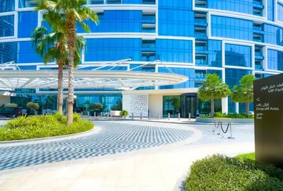 a building with a palm tree in front of it at ADDRESS BEACH RESORT Residence Million Dollar View 39th floor DXB AIRPORT VIP Shuttle option in Dubai