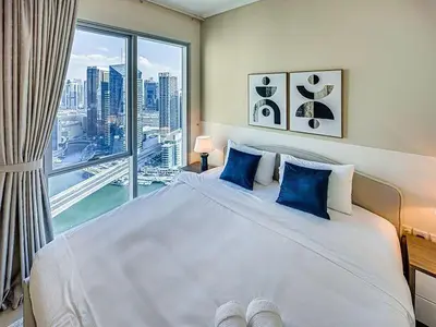 a bedroom with a large bed with a large window at Bright 3BR with Maid, Sofa Bed, Marina Views - 32AB02 in Dubai