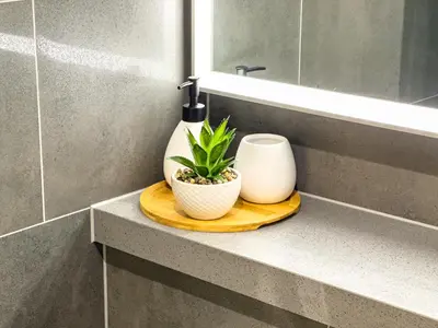 a bathroom with a counter with a bottle and a plant at Luxury 1BR, The Crest, Sobha Hartland in Dubai