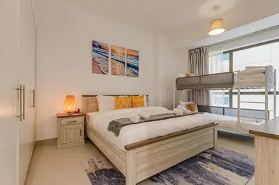 a bedroom with a bunk bed and a window at Shams, JBR - 2BR Apartment - Allsopp & Allsopp in Dubai