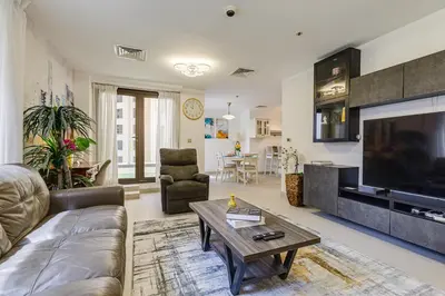 a living room with a couch and a tv at Shams, JBR - 2BR Apartment - Allsopp & Allsopp in Dubai