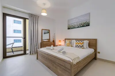 a bedroom with a large bed and a window at Shams, JBR - 2BR Apartment - Allsopp & Allsopp in Dubai